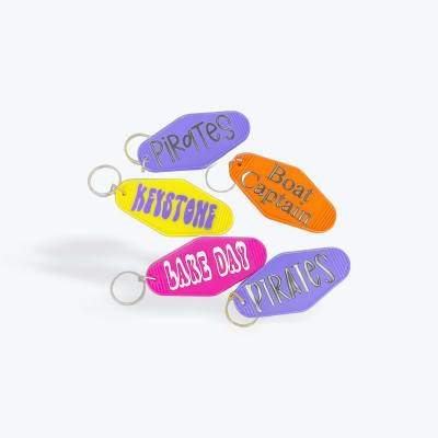 Colorful plastic keychains labeled with pirate-themed roles