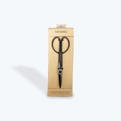 Packaged black trimming shears on a cardboard backing
