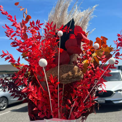Tall red foliage arrangement with pampas grass and decorative stems