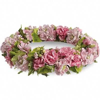 Pink floral lei with green leaves on a white background