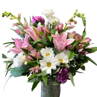 Pink lilies and white daisies in a glass vase