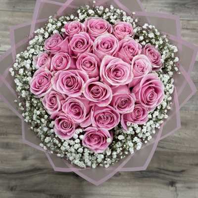 Round bouquet of pink roses with white baby's breath