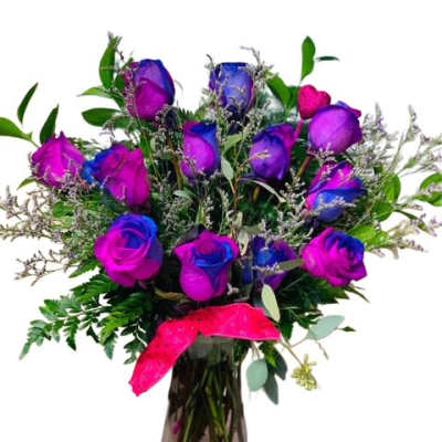 Bouquet of dyed purple and blue roses in a glass vase