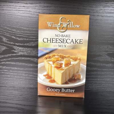Box of Wind & Willow no-bake cheesecake mix on a dark table