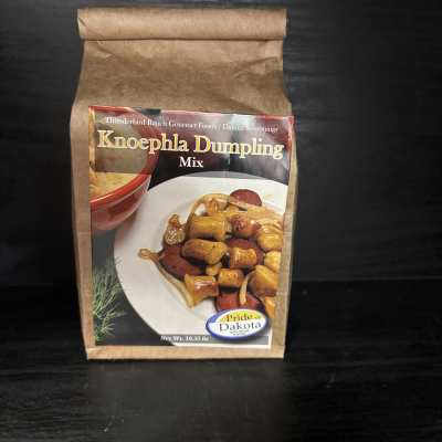 Brown paper pouch of Knoephla Dumpling Mix on a dark surface