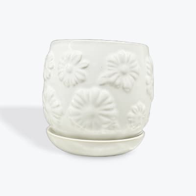 White ceramic planter with embossed floral pattern and matching saucer