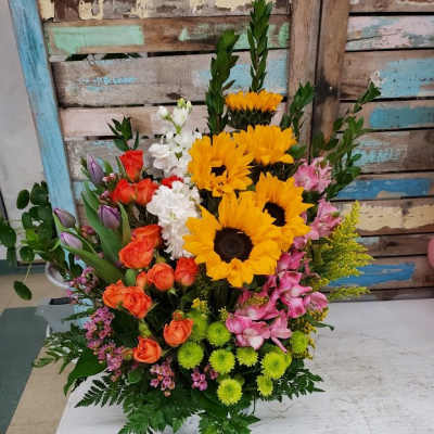Mixed bouquet with sunflowers, roses, and alstroemeria in a vase