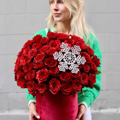 Large bouquet of red roses with a white snowflake decoration in a red box