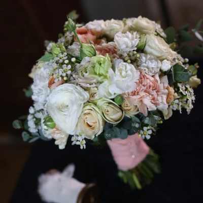 Hand-tied bouquet of white, blush, and peach flowers