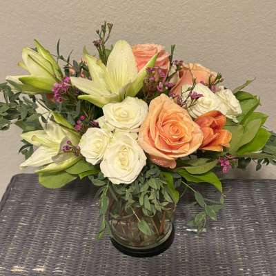Bouquet of roses and lilies in a glass vase