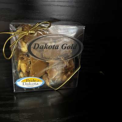 Boxed candy with a gold ribbon and label