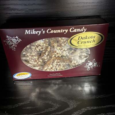 Box of Dakota Crunch candy on a dark table