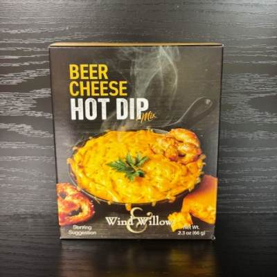 Box of beer cheese hot dip mix on a dark wood surface