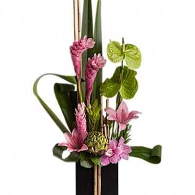 Pink tropical flowers arranged in a tall black vase