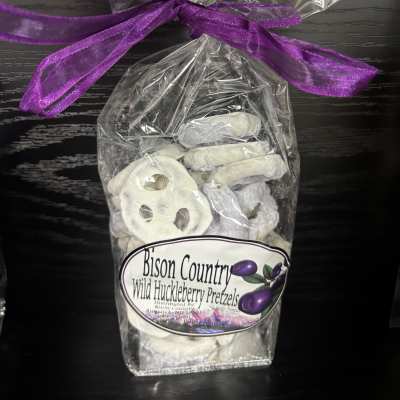 Bag of white chocolate-covered pretzels tied with a purple ribbon