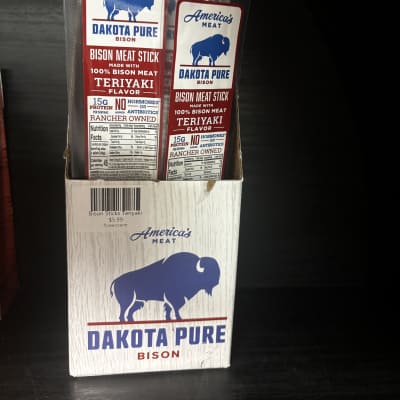 Box of Dakota Pure bison meat sticks in clear plastic packs