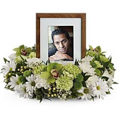 Framed photo surrounded by white and green flowers