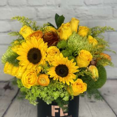 Yellow bouquet with sunflowers and roses in a black box