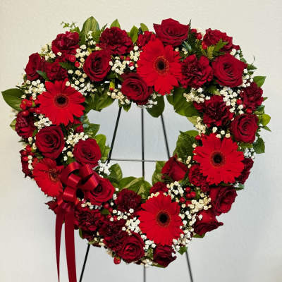 Heart-shaped floral wreath with red roses and gerbera daisies