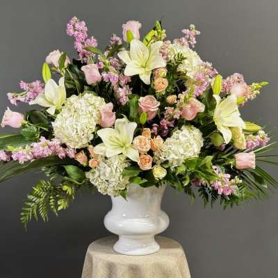 Pink and white floral arrangement in a white vase