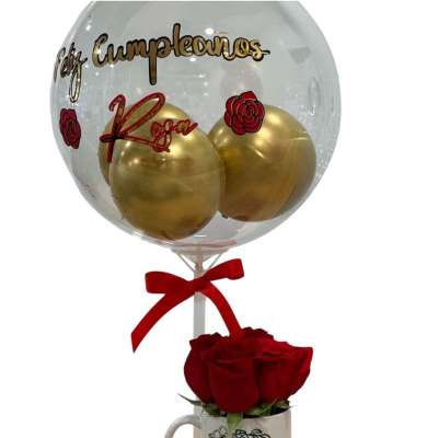 Birthday gift set with clear balloon and golden balloons above a mug of red roses