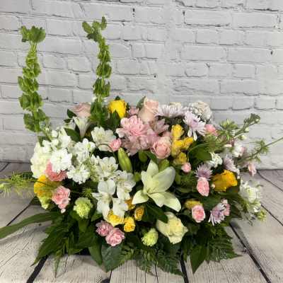 Mixed floral arrangement with white lilies, pink roses, and yellow blooms