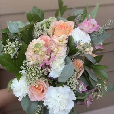 Bouquet of peach, pink, and white flowers with greenery