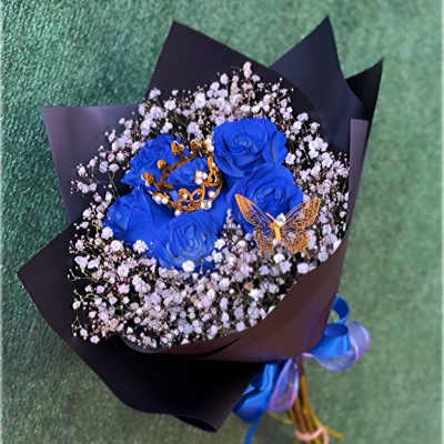 Bouquet of blue roses with baby's breath and decorative butterfly accents