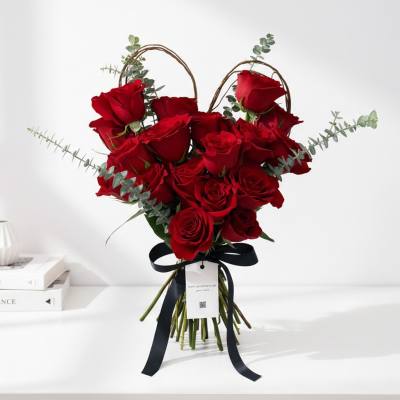 Bouquet of red roses with eucalyptus and a black ribbon