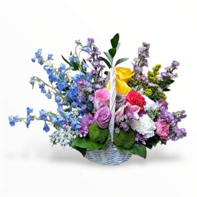 Basket arrangement with blue and purple flowers, roses, and carnations