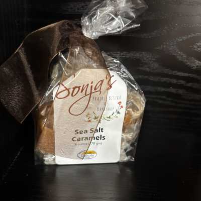 Wrapped bag of sea salt caramels with a brown ribbon