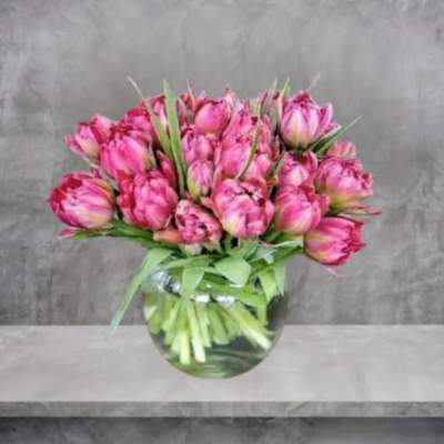 Pink tulips arranged in a clear glass vase