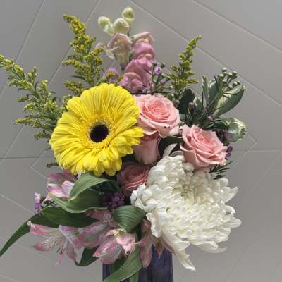 Bouquet of pink roses, white chrysanthemum, and yellow gerbera in a vase