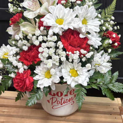 Red and white mixed bouquet in a mug-shaped vase