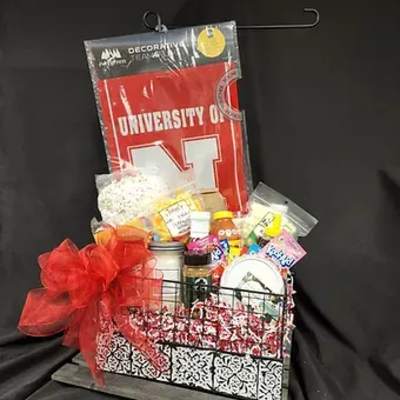 Gift basket with snacks and a red University of Nebraska item