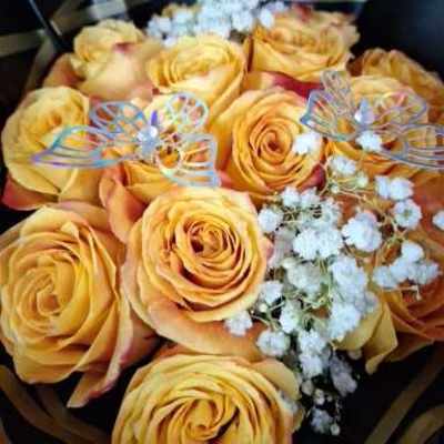 Bouquet of yellow roses with baby's breath and butterfly picks