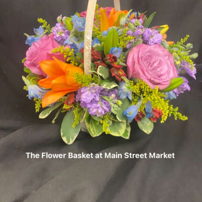 Colorful flower basket with pink roses and orange lilies