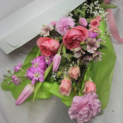 Pink and lavender bouquet in a white box with a pink ribbon