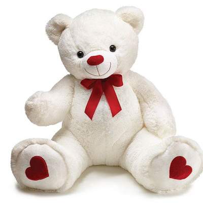 White teddy bear with a red bow and heart-shaped paw pads