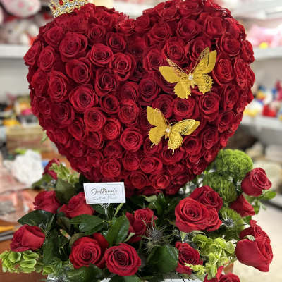 Heart-shaped red rose arrangement with yellow butterfly accents