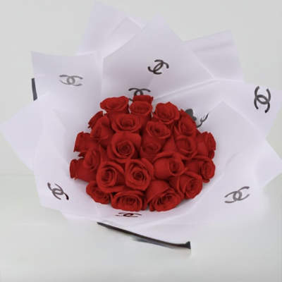 Bouquet of red roses wrapped in white paper