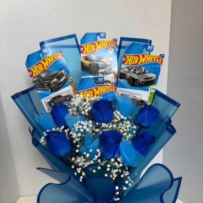 Blue roses and baby’s breath arranged with Hot Wheels toy car packages