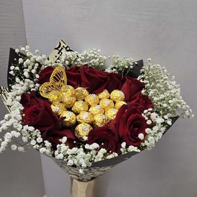 Bouquet of red roses with white baby's breath and gold chocolates