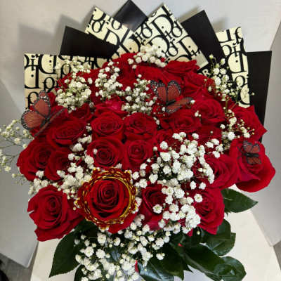 Bouquet of red roses with white baby's breath and butterfly accents
