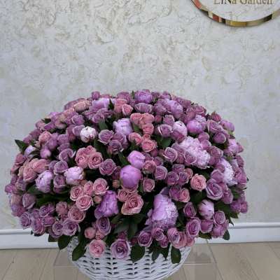 Large basket of pink and lavender roses and peonies
