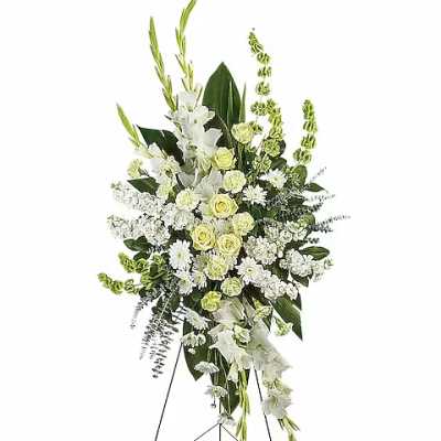 White floral standing spray on a metal easel