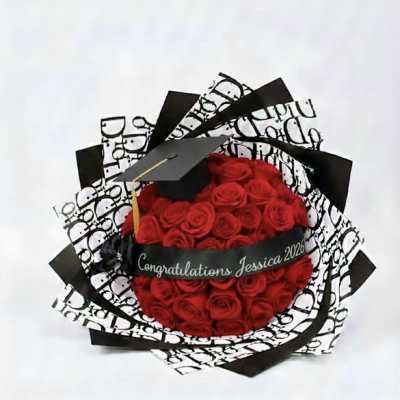 Red rose bouquet with a graduation cap and black-and-white wrapping