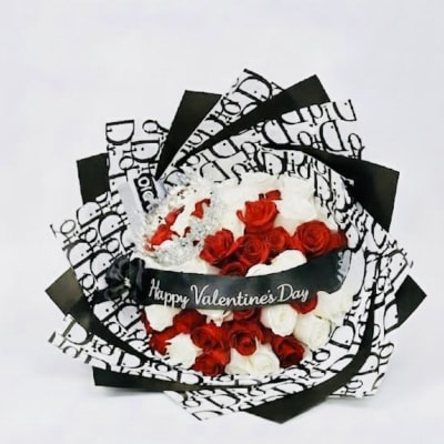 Bouquet of red and white roses wrapped in black-and-white paper