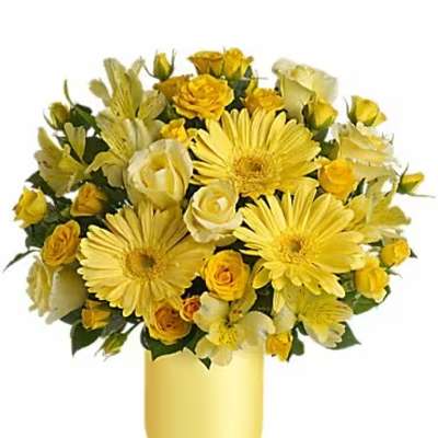 Yellow bouquet of gerbera daisies and roses in a yellow vase