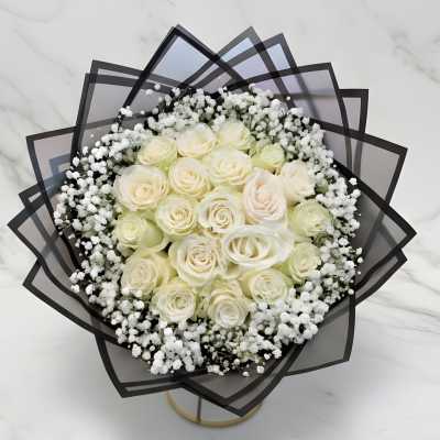 Bouquet of cream roses with white baby's breath in black wrap